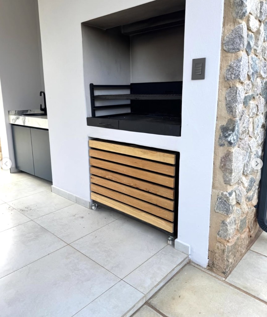 Wood slat storage unit in outdoor braai area